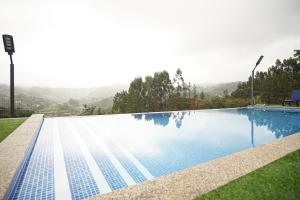 ein Schwimmbad mit einem Berg im Hintergrund in der Unterkunft Quinta do Além 