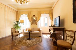 a living room with a couch and a table and chairs at Palazzo Lari Luxury Accommodation in Sarzana