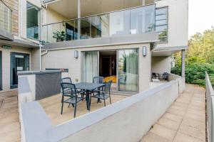 a house with a table and chairs on a balcony at Lovely One Bedroom Flat in Bournemouth