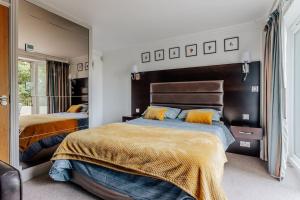 a bedroom with two beds and a large mirror at Lovely One Bedroom Flat in Bournemouth