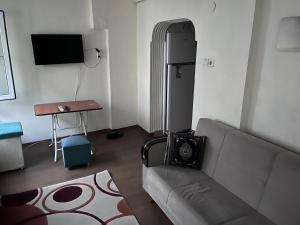 a living room with a couch and a refrigerator at Fatih Eco 3 Apart in Istanbul