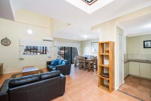 una sala de estar con un sofá y una mesa en Ocean Sunsets - 2 bedroom converted warehouse apartment, en Fremantle