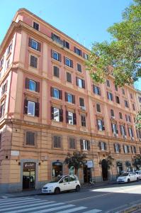 a large brick building with cars parked in front of it at Colonna Luxury Apartment in Rome