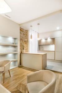 a kitchen and living room with a couch and a table at LYON HYPERCENTRE LES CORDELIERS in Lyon