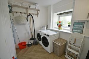 a laundry room with a washing machine and a window at Pendle Hill Farm - 5* Luxury, Log fire, Parking in Burnley
