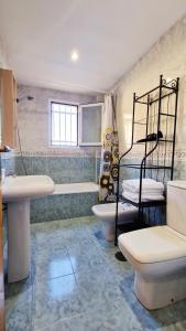 a bathroom with a sink and a toilet and a tub at AA Guest - Don Juan Eco Front Sea Views Apartment in Fuengirola