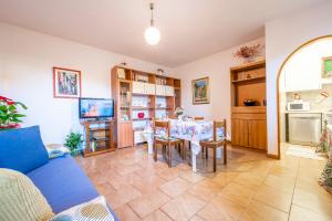 a living room with a blue couch and a table at La Casetta di Silvia in Piano di Mommio