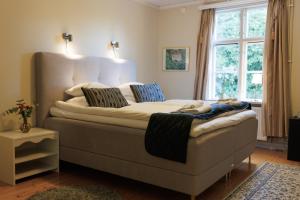 a large bed in a room with a window at Munkedals Herrgård in Munkedal +116 photos