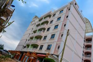 a large white building with balconies on it at The Lotus Stay-in at Paradise Apartments, Embu in Embu