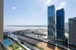 a view of a city with tall buildings and a river at The Peak Residence by Caerus Management in Phnom Penh