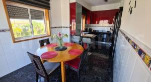 a kitchen with a wooden table and chairs in a kitchen at Casa Ramos in Póvoa de Varzim