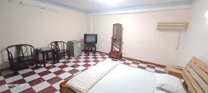 a bedroom with a bed and a checkered floor at Nhật Bình 2 in Ho Chi Minh City