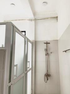 a shower with a glass door in a bathroom at Changami Residence in Nugegoda