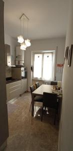 a kitchen and dining room with a table and chairs at La Buona Stella Apartment in Pistoia