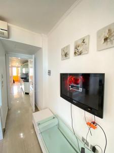 a living room with a flat screen tv on a wall at شاليه في بورتو مارينا الساحل الشمالي العلمين شاليه دور 9 in El Alamein