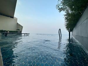 a pool of water next to a building at The Peak Residence by Caerus Management in Phnom Penh