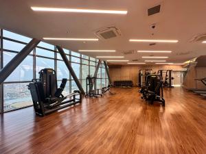 a gym with treadmills and exercise equipment in a building at The Peak Residence by Caerus Management in Phnom Penh
