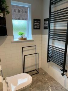 a bathroom with a toilet and a window at Ramshill House in Cracoe +10 photos