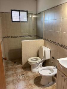 a bathroom with a toilet and a sink at Casa 7 Cerros in Piriápolis