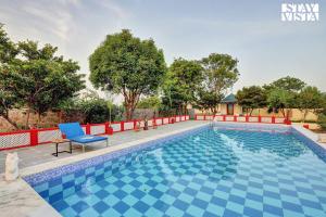 an image of a swimming pool in a villa at Jungle Retreat by VEO - Part of StayVista in Bāli