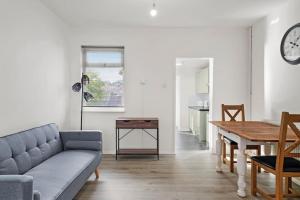 a living room with a couch and a table at Hoan Place in Strood