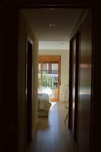 a hallway with a bedroom and a bed and a window at Barraca Beach in Valencia