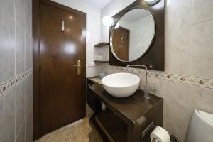 a bathroom with a sink and a mirror at Luz y Color en Castelldefels in Castelldefels +16 photos