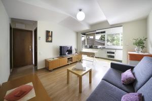 a living room with a couch and a table at Luz y Color en Castelldefels in Castelldefels