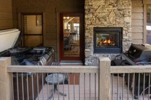 a porch of a house with a fireplace at Base Camp at Iron Horse,,, townhouse in Winter Park