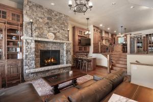 a living room with a couch and a fireplace at Base Camp at Iron Horse,,, townhouse in Winter Park
