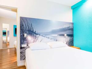 - une chambre avec une fresque murale représentant la plage dans l'établissement ibis Styles Quimper, à Quimper