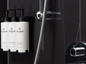 two white bottles ofodorizers are sitting in a bathroom at Sofitel London Gatwick in Horley