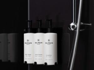 a group of three white bottles of shampoo at Sofitel London Gatwick in Horley