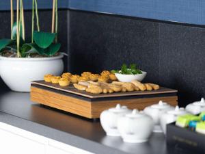 a tray of food on a table with bowls of food at Sofitel London Gatwick in Horley