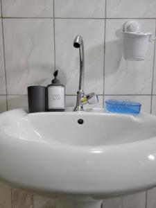 a bathroom sink with a faucet on it at Rozy homes Jinja in Jinja