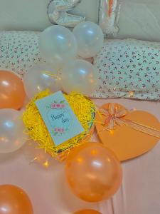 a table topped with balloons and a birthday cake at Homestay Tuyết Trinh in Nha Trang