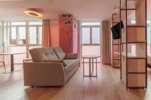 a living room with a couch and a table at Apartamentos Valladolid Centro in Valladolid