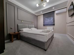 a bedroom with a bed and a television in it at Hotel Senator Konferencje & SPA in Starachowice
