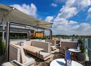 a patio with tables and chairs on a balcony at Claire's Retreat, Rudd Lake, Tattershall Lakes in Tattershall