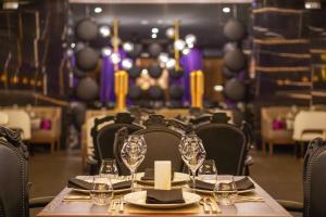 a dining room with a table and chairs with wine glasses at Hyatt Regency Grand Reserve Puerto Rico in Rio Grande