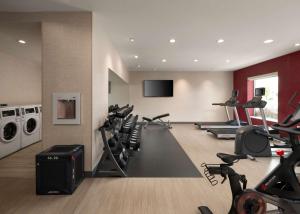 a gym with treadmills and machines in a room at Home2 Suites Troy, OH in Troy