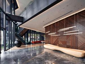 a lobby with a wooden wall with a bench at Pullman Lima Miraflores in Lima