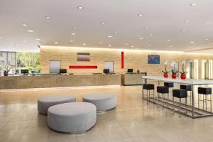 a lobby with stools and a bar in a building at Vienna House by Wyndham Andel's Prague in Prague