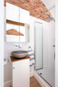 a bathroom with a sink and a shower at Badgers Cottage in Fittleworth