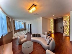 a large living room with a couch and chairs at Sky Tower Hotel in Batumi