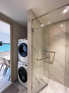 a washer and dryer in a bathroom with a washing machine at Once Pattaya in Pattaya Central