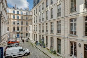 a street in a city with a white car parked next to buildings at 148 Suite Jacky, Superb APT, Center of Paris in Paris