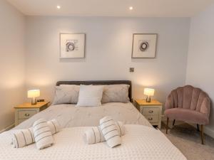 a bedroom with a bed and a chair and two lamps at Pass the Keys Bouvardia Modern town centre apartment in Shrewsbury