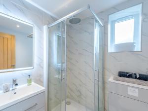 a bathroom with a glass shower and a sink at Pass the Keys Bouvardia Modern town centre apartment in Shrewsbury