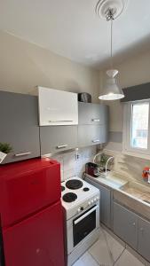 a kitchen with a red stove and a red refrigerator at Central flat - 2 Metro stops from ACROPOLIS-PLKA in Athens